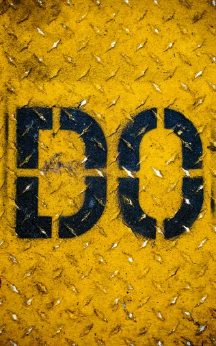 the letters of the word pc are written on a yellow surface