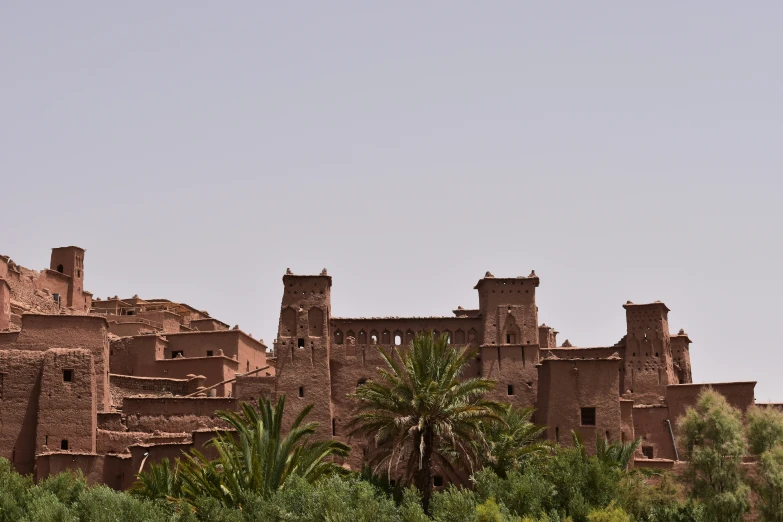 a building with lots of walls near trees