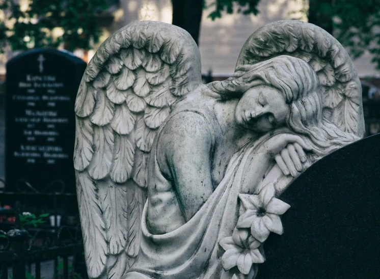 an angel statue on the grave of an unknown person