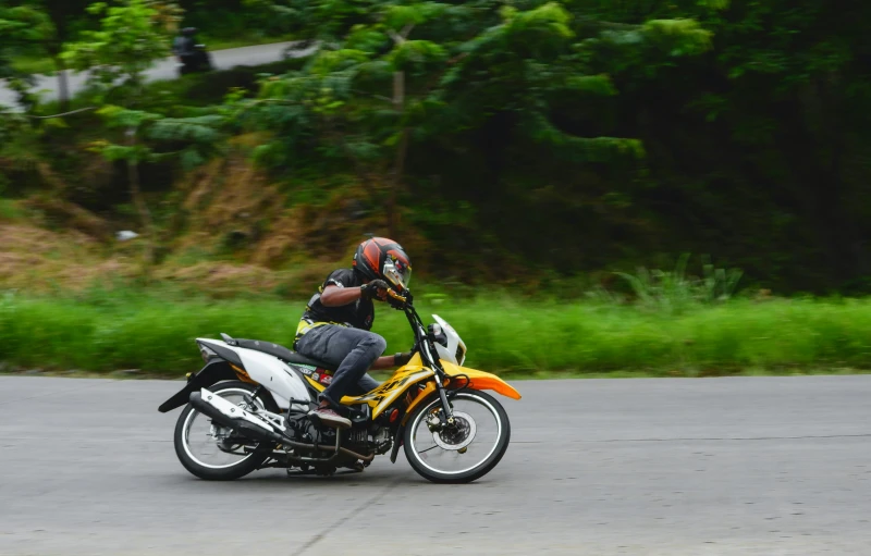 a man is driving a motorcycle in the street