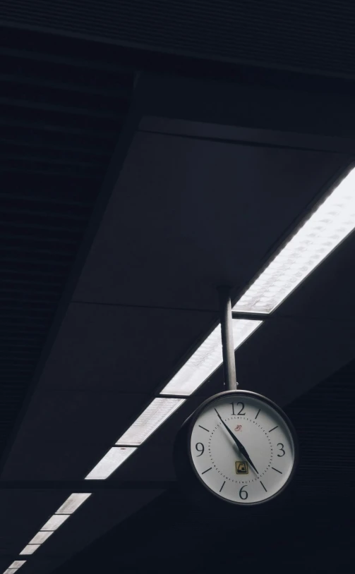 a clock in a garage is illuminated by light