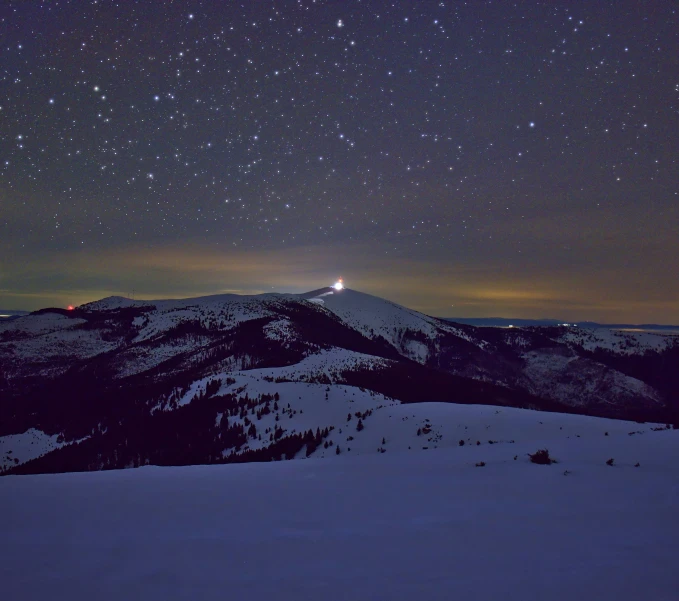 mountains with snow on them and some night sky