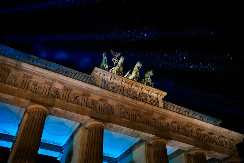 the top of an old building with blue lights lit up