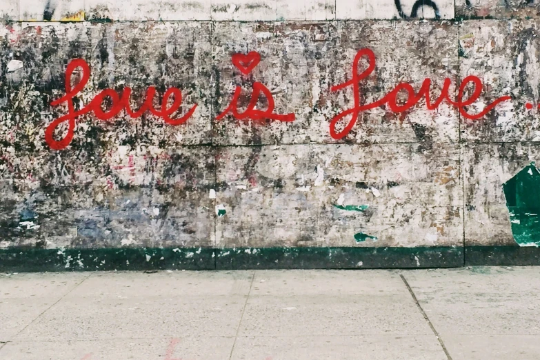 a mural depicting the phrase love is yours written in red letters