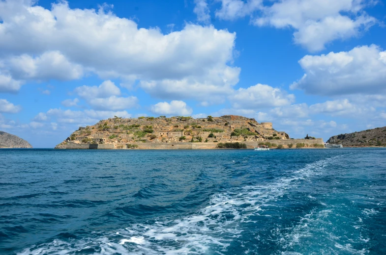 blue waters with a large hill on it and sky