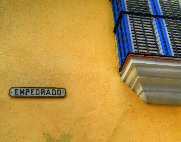 a street sign attached to a building near a window