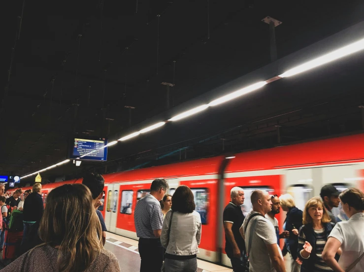 passengers are waiting for the train to arrive at the station