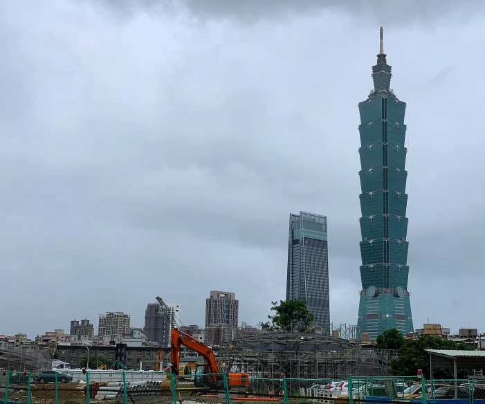 large cranes on land in front of buildings