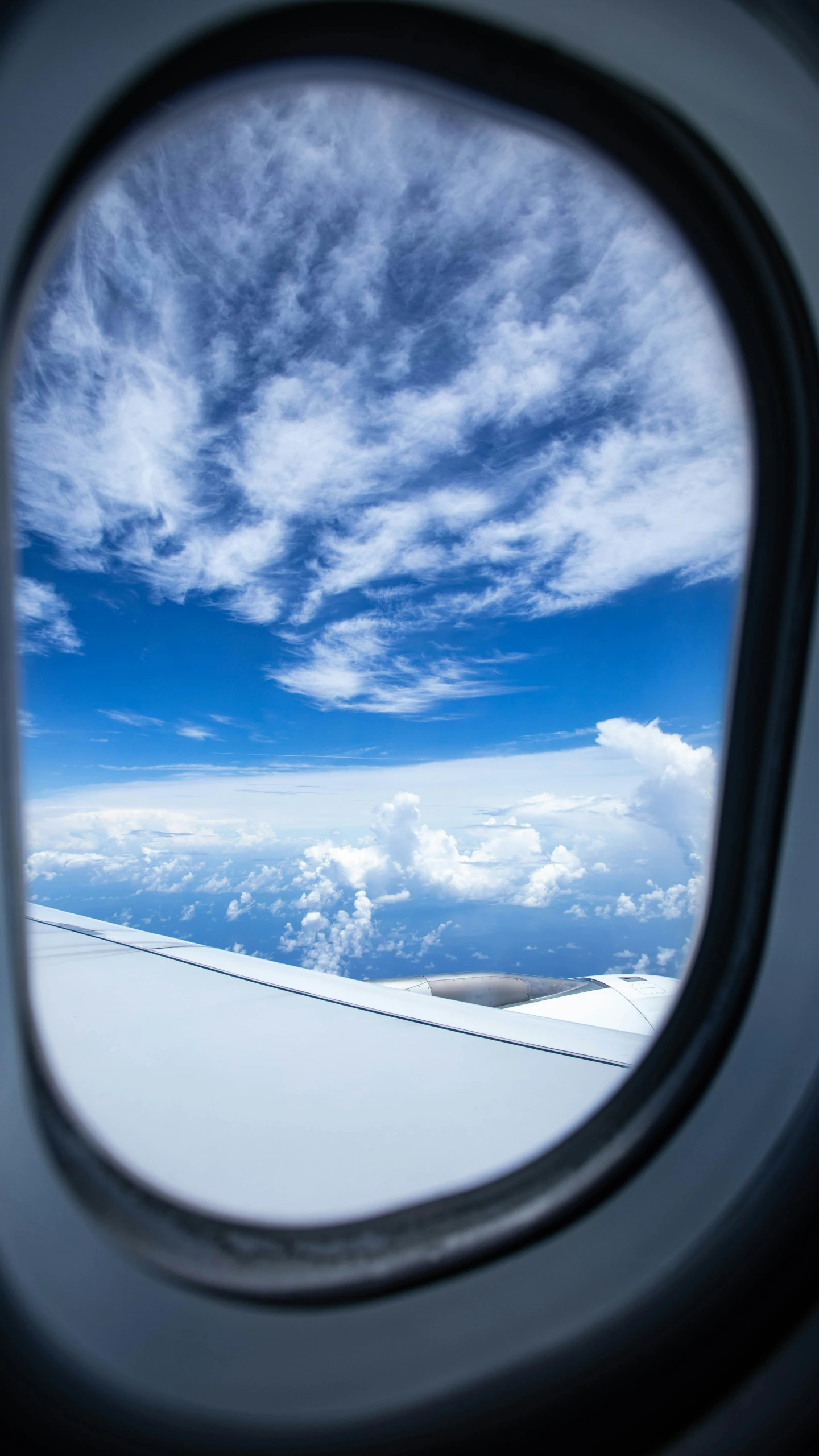 an airplane window looking out onto the clouds