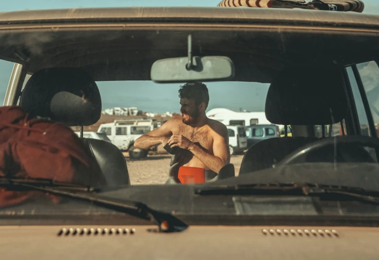 a man standing in the back seat of a truck