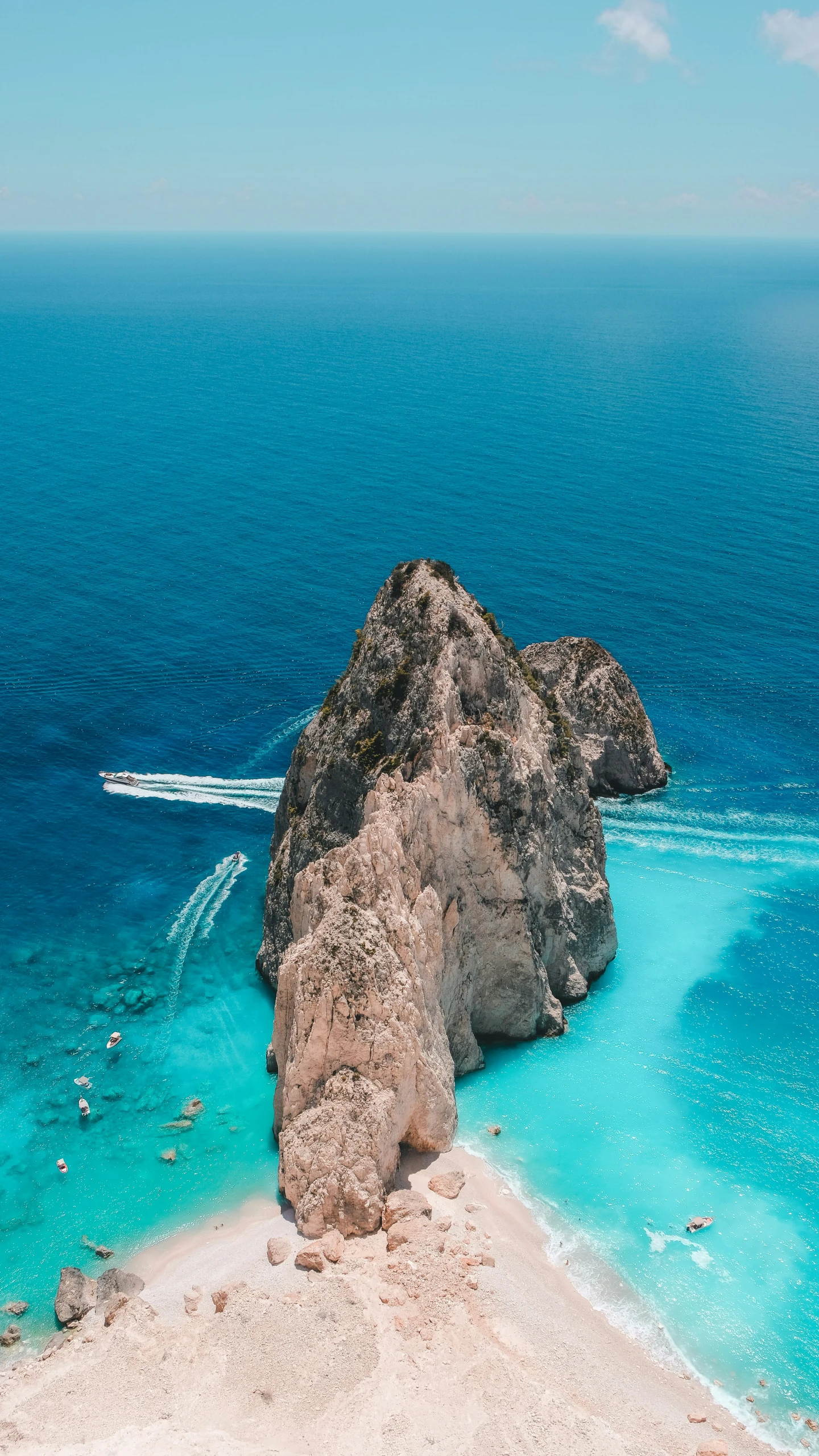 a beautiful beach with a boat and turquoise waters
