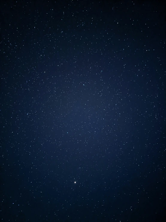 a view of a very deep blue space with some stars