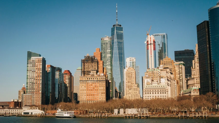 a body of water with tall buildings in the background