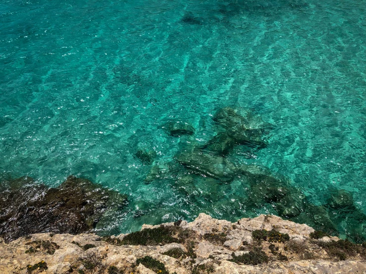 an ocean view from above of rocks and water