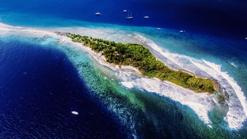 an island surrounded by water and other small boats