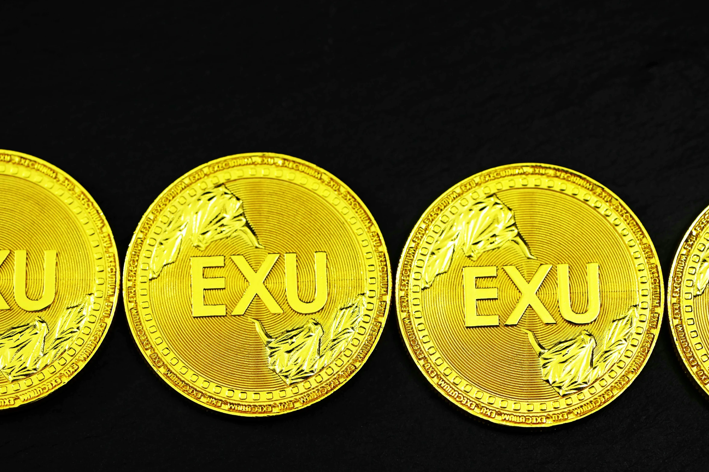 three golden gold sovereign coins sitting on top of each other