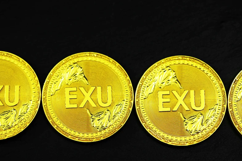 three golden gold sovereign coins sitting on top of each other