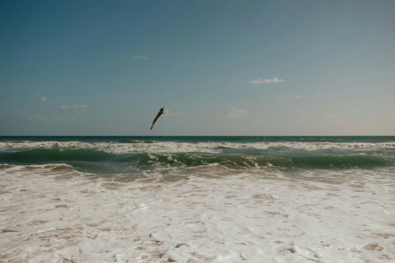 a large kite that is in the air above water