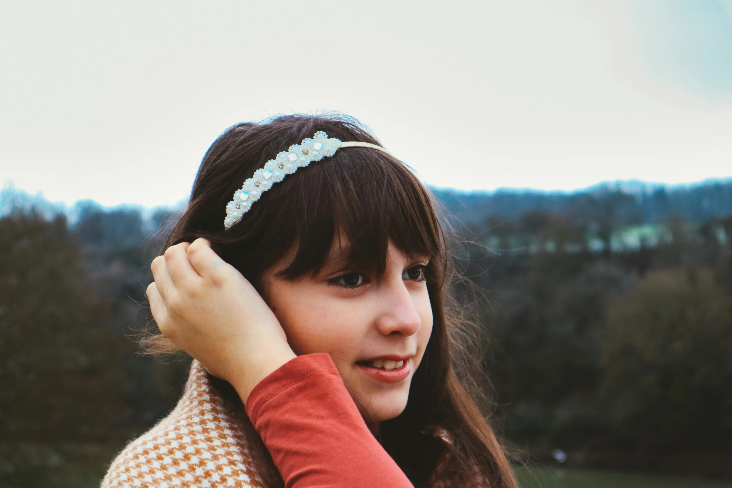 a woman is posing with a hair band on her head