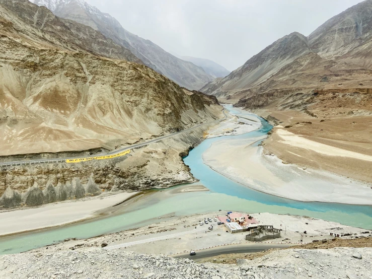 the view of a mountain range and a river near mountains