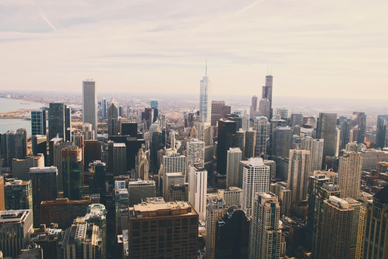 a city filled with tall buildings near the ocean