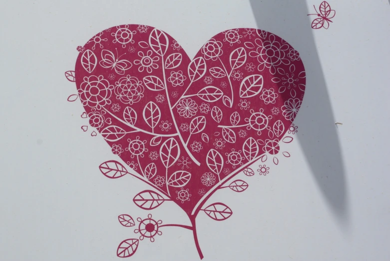 a piece of paper with an illustration of a red heart surrounded by flowers