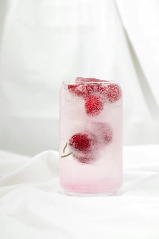 a strawberry tea is in a glass with ice