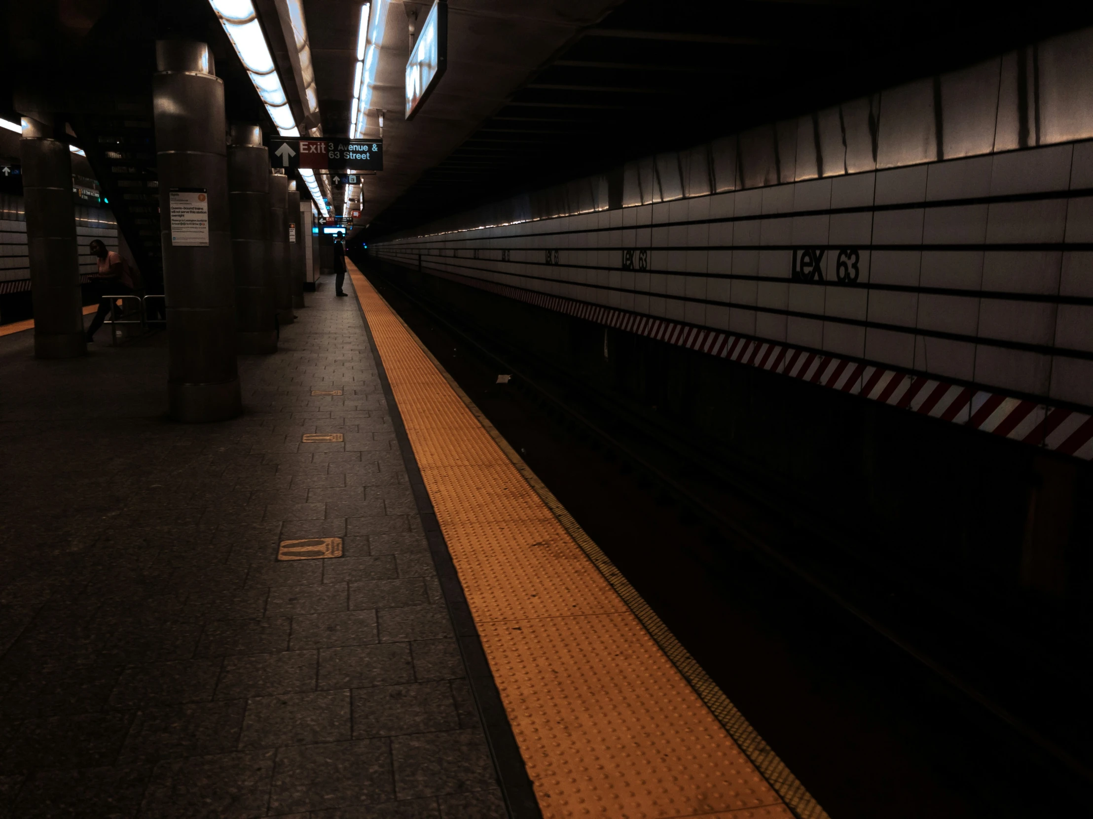 a subway station with people walking in the dark