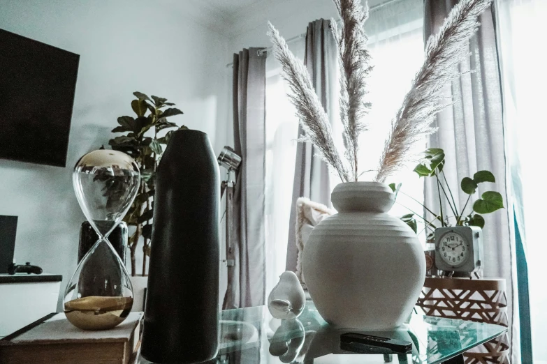 glass table with vase and other items inside