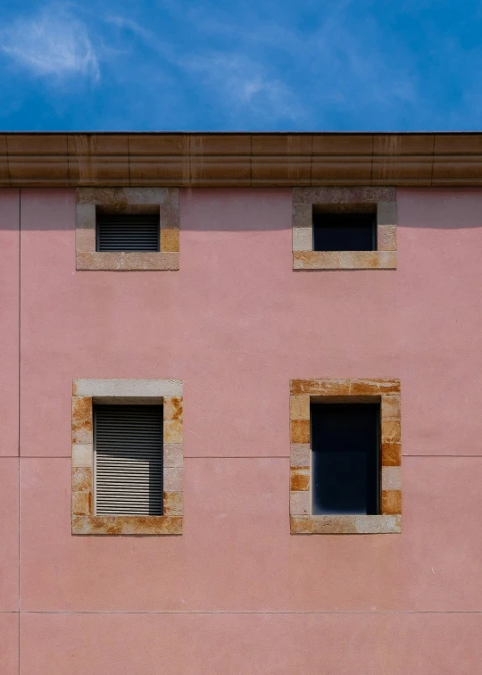 a cat sleeping in front of a pink wall