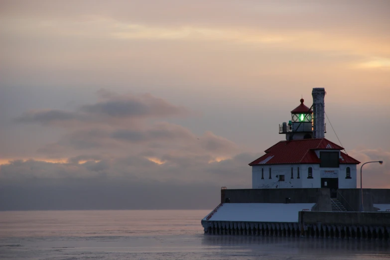 an island with a lighthouse in the middle on top of the water