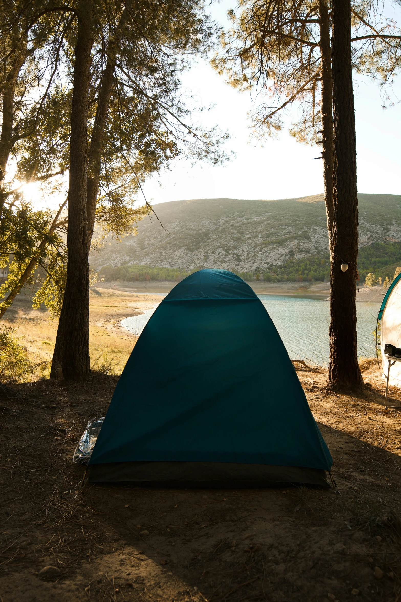 an outdoor camping area overlooking a lake