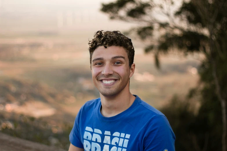 a man in a blue shirt and a view