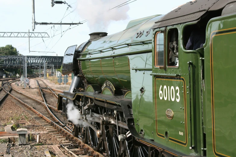 a steam engine train riding on a train track