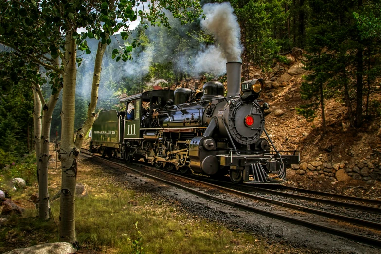 an old fashioned train going down a set of tracks