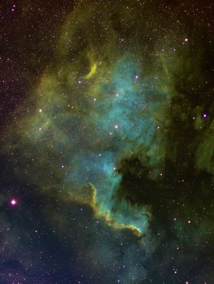 the green and yellow star cluster is surrounded by bright stars