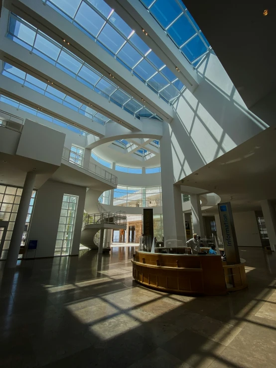 a lobby with white walls and large windows