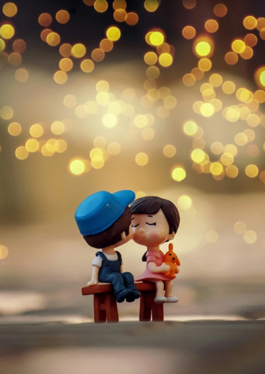 a miniature couple kissing on the bench next to christmas lights