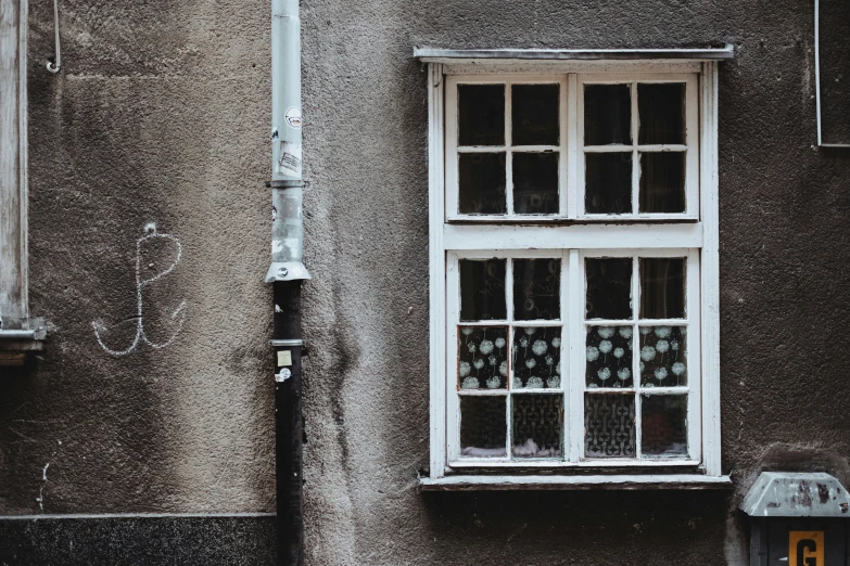 a building with two windows and a lamp post