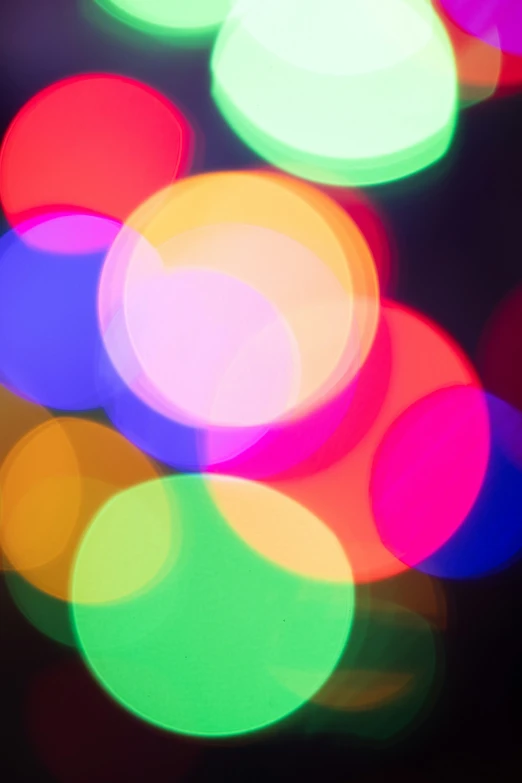 a close up image of colorful lights in the dark