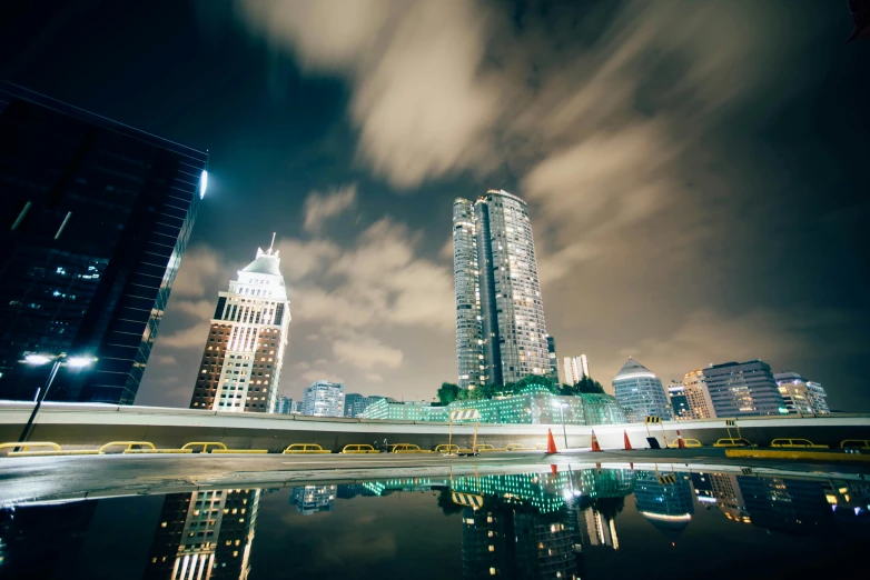 a nighttime scene with lights and skyscrs reflected in the water