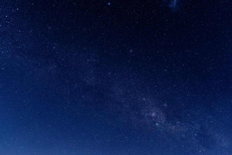 an airplane flies high above a body of water at night