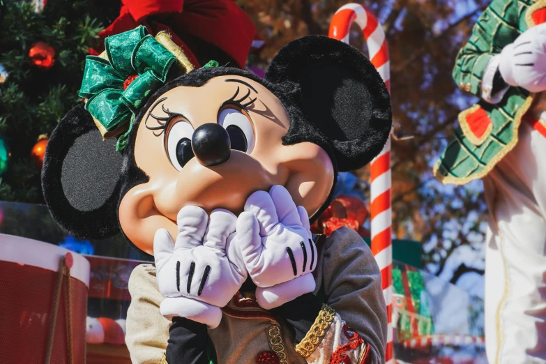 a mickey mouse wearing a christmas costume