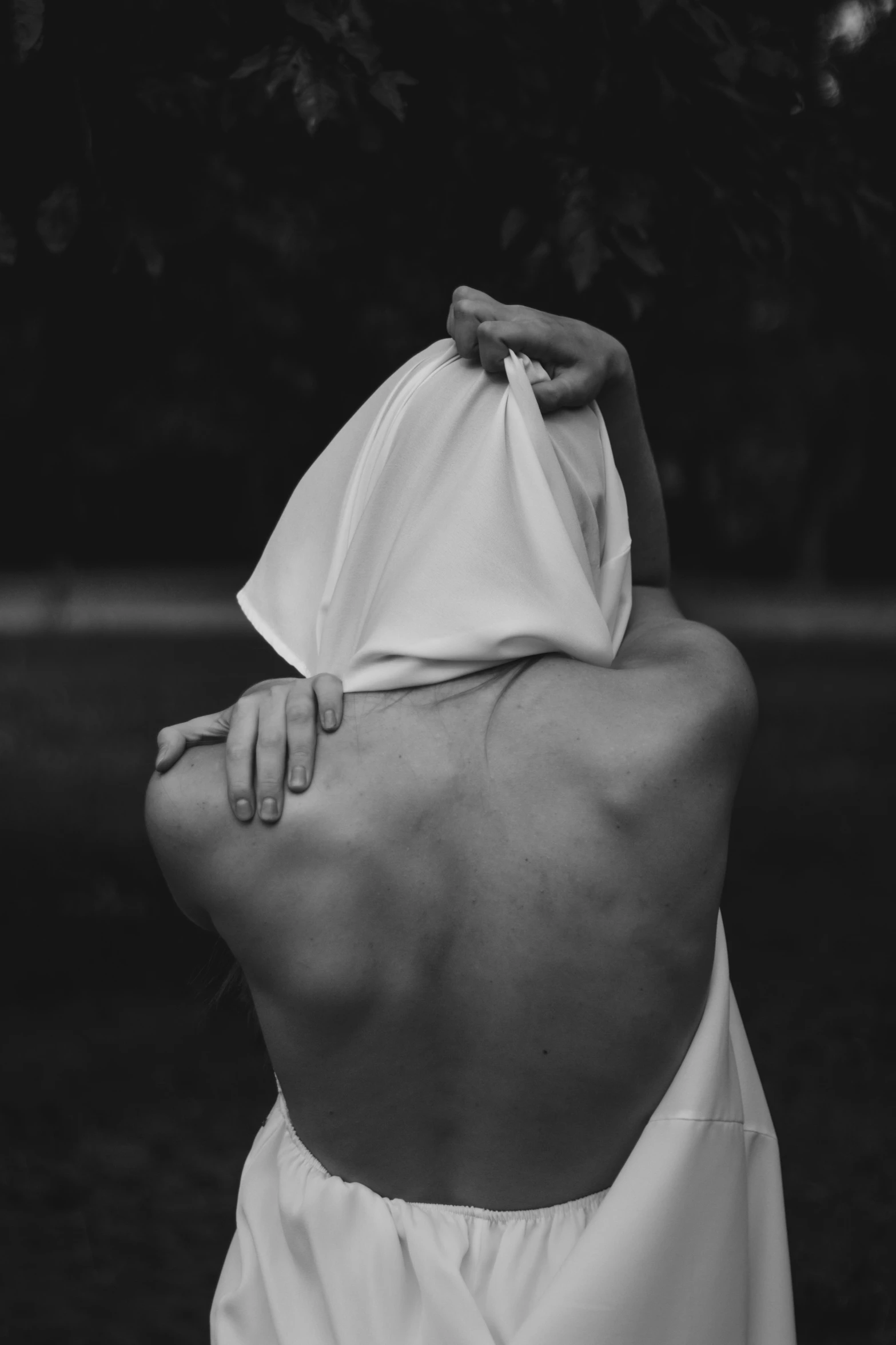 a woman has a white shirt covering her neck