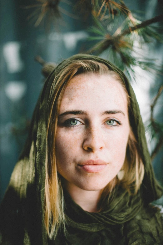 a woman with a hoodie on has an intense look