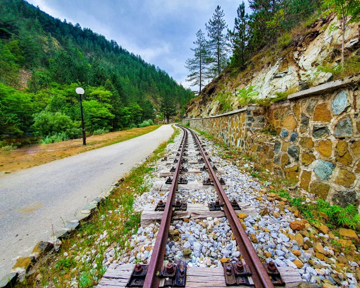 a railroad track stretches into the distance, with a street lamp