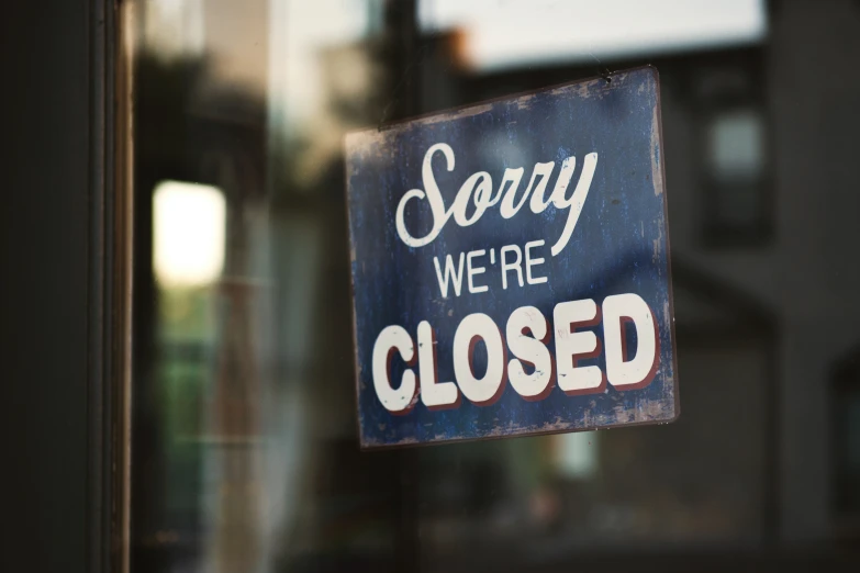 a closed sign is hanging on a store