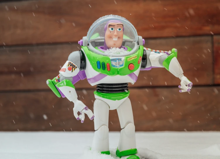 a toy action figure standing on a white surface