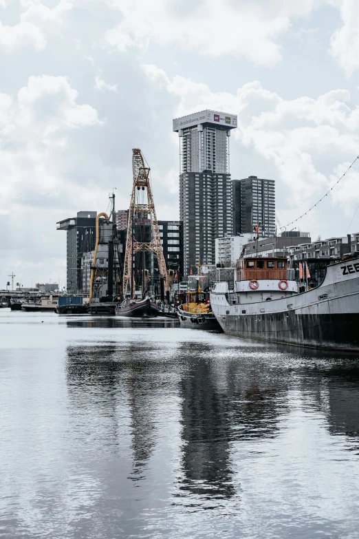 a boat parked in front of a city next to the water