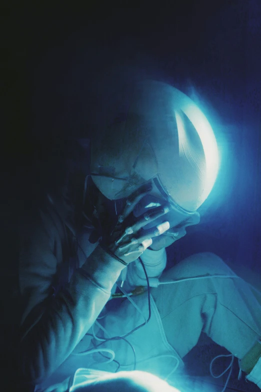 a man using his hand light bulb in the dark